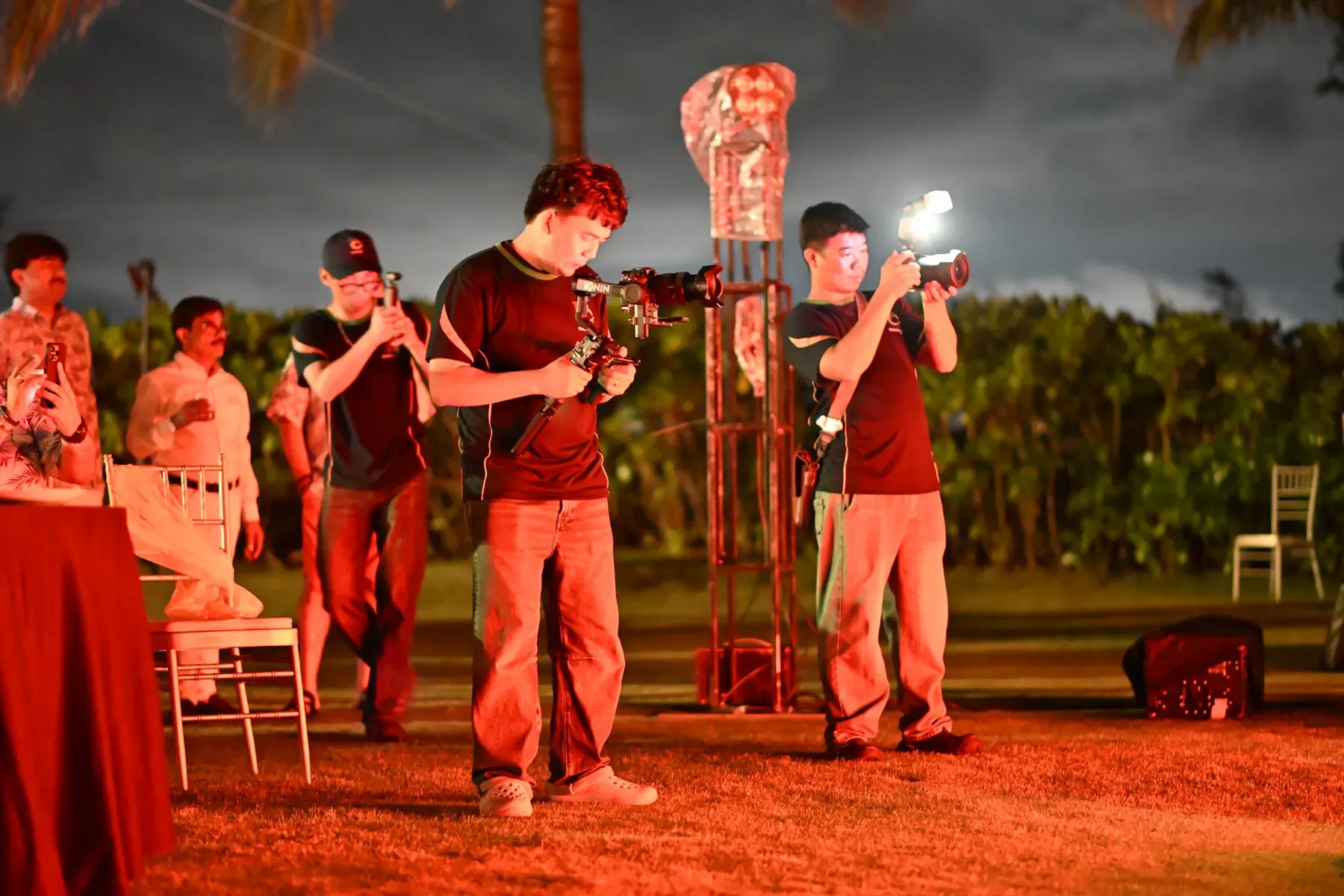 Phu Quoc Times Media camera crew photographing and filming an outdoor event.