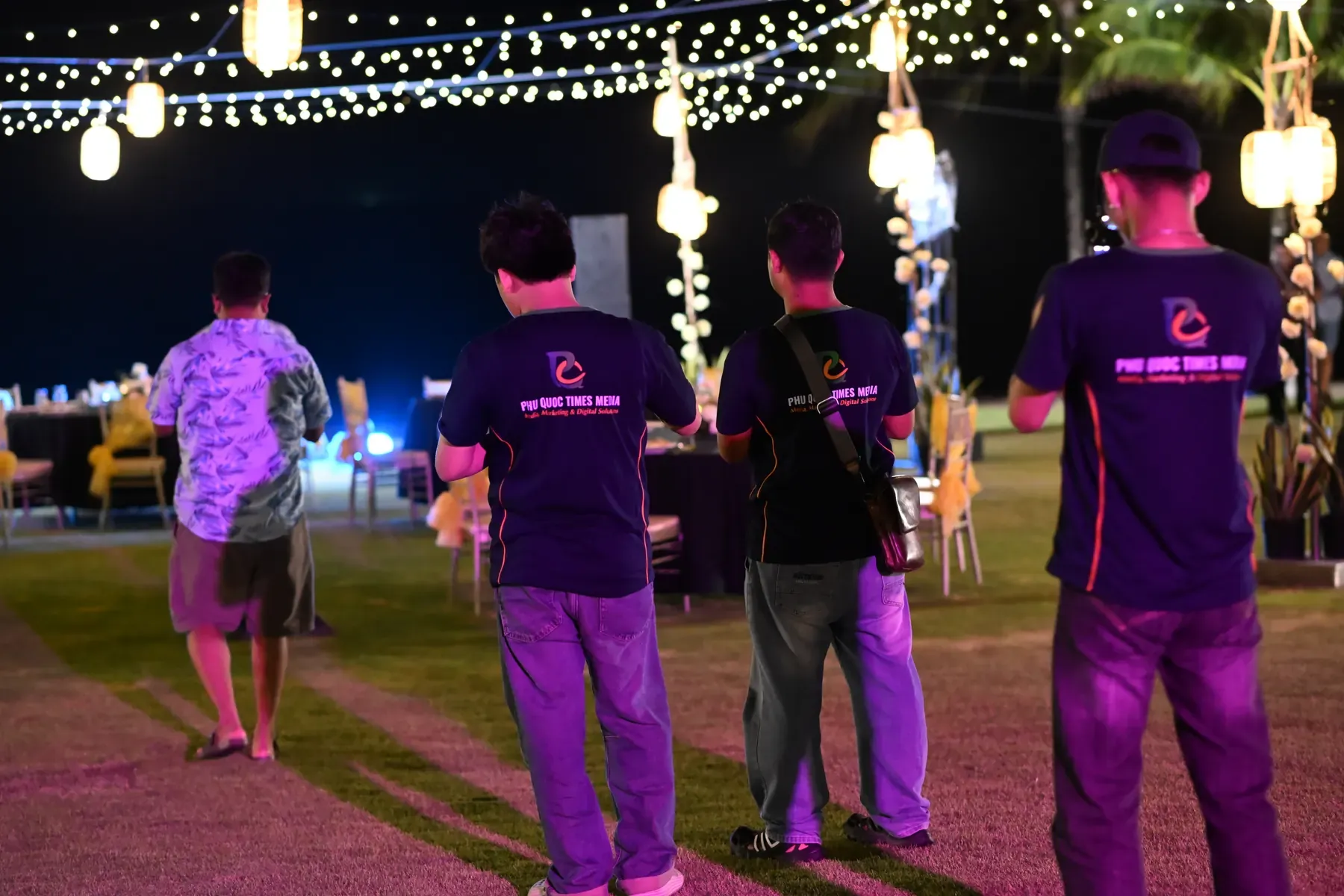 Phu Quoc Times Media crew moving through an outdoor event venue.