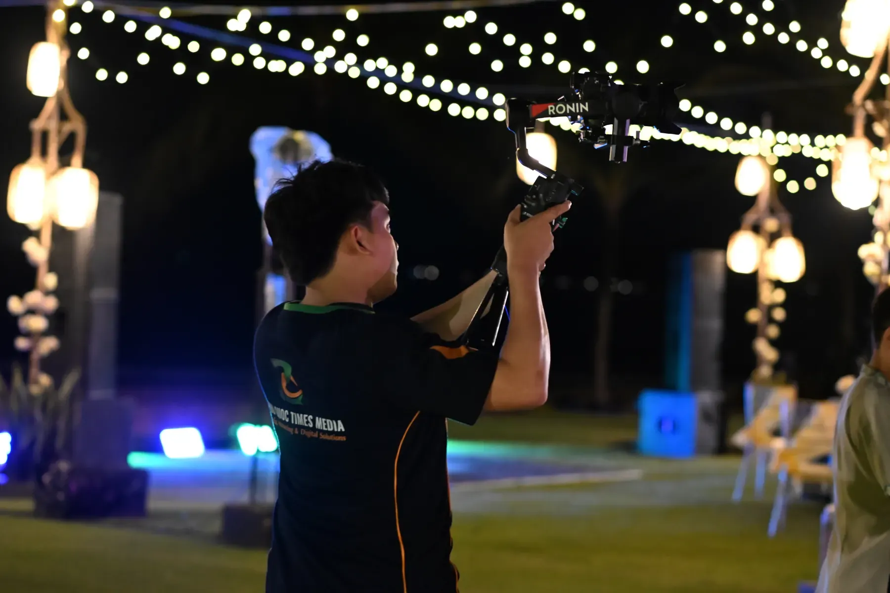 Phu Quoc Times Media filmmaker operating a camera stabiliser at night.